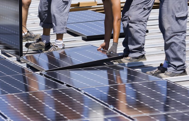Technician Installing Solar Panels
